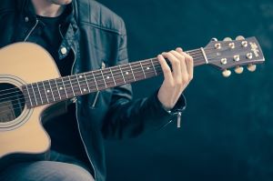 a man with a guitar in hand