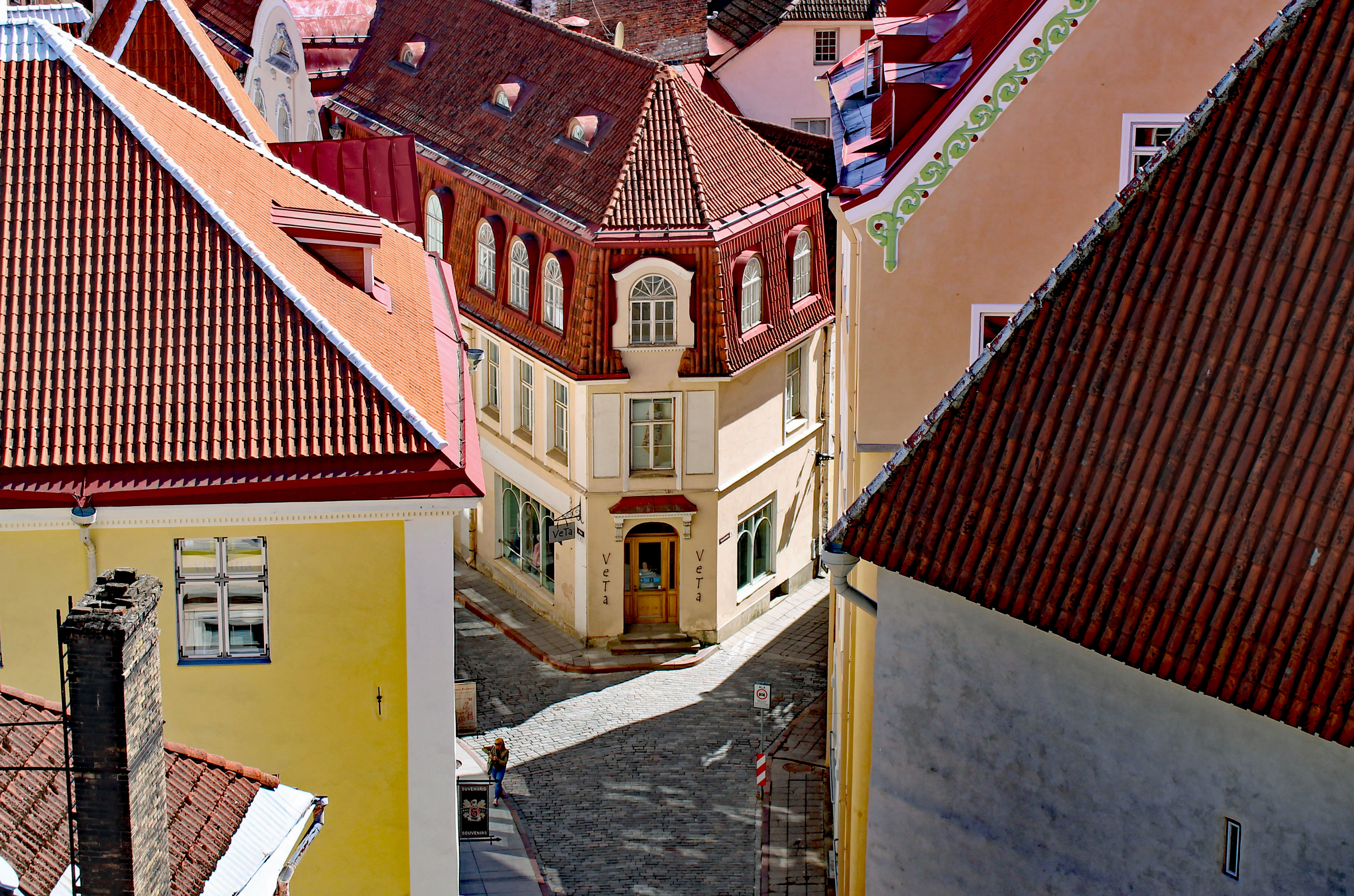 view down from a high building to cobbled streets and red roofed houses